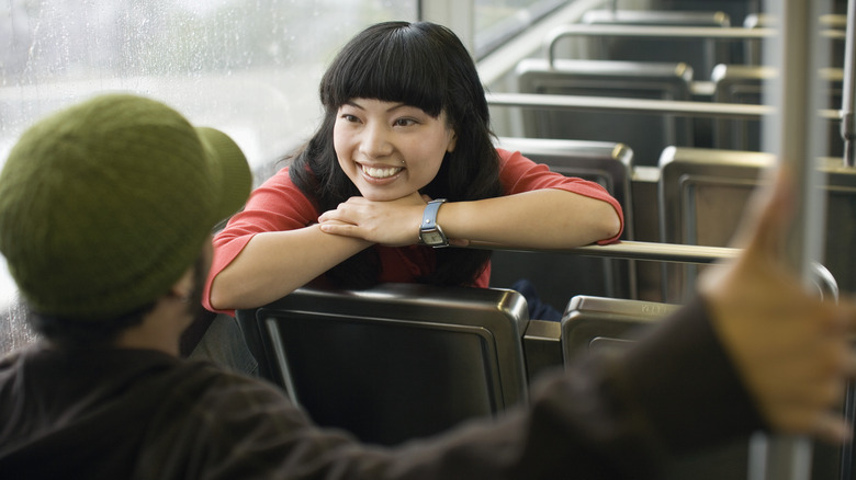 Couple talking inside a bus