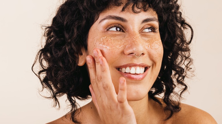 woman applying face scrub