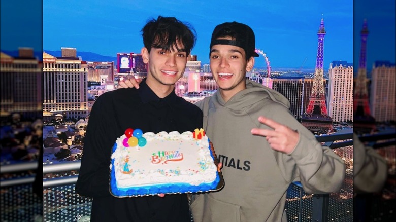 The Dobre Twins with a cake