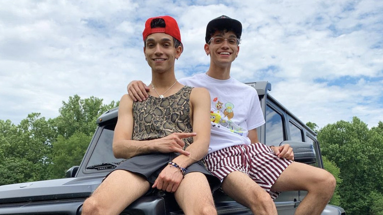 Marcus and Lucas pose with one of their cars