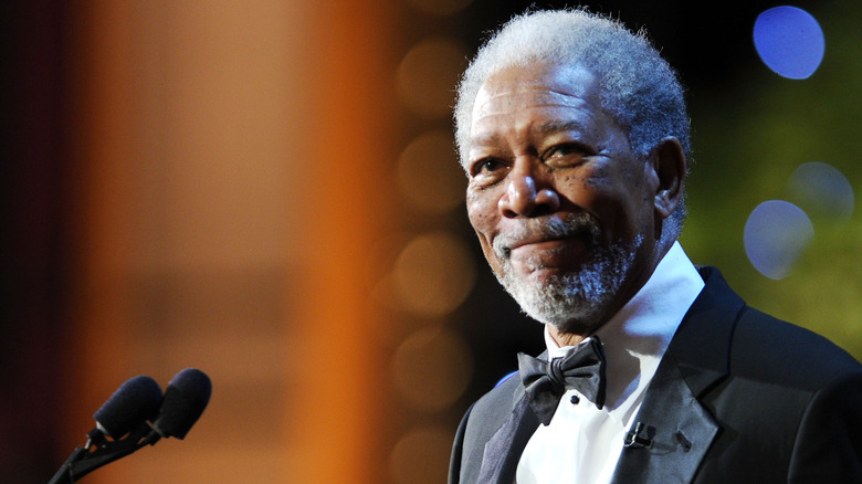 Morgan Freeman smiling in a tuxedo onstage