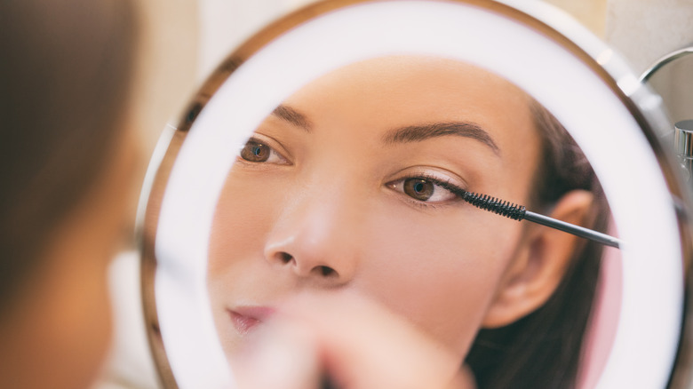 Applying makeup with ring light