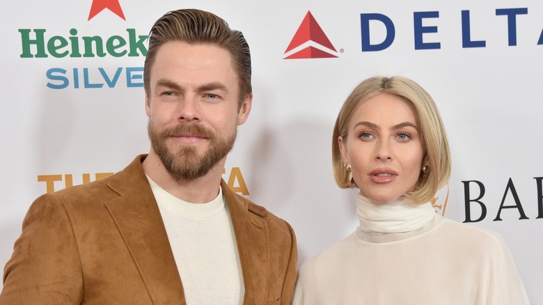 Derek Hough and Julianne Hough standing together on the red carpet