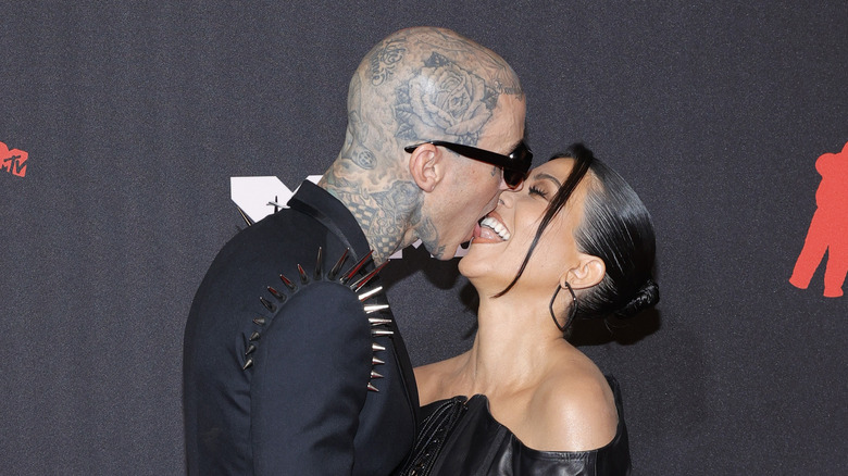 Travis Barker, Kourtney Kardashian kissing, laughing