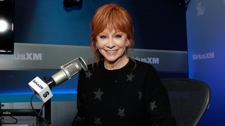 Reba McEntire sitting next to microphone