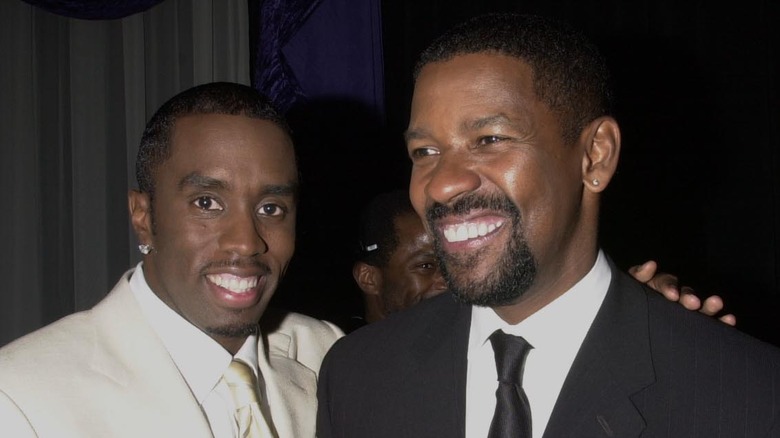 Sean 'Diddy' Combs smiling next to Denzel Washington.