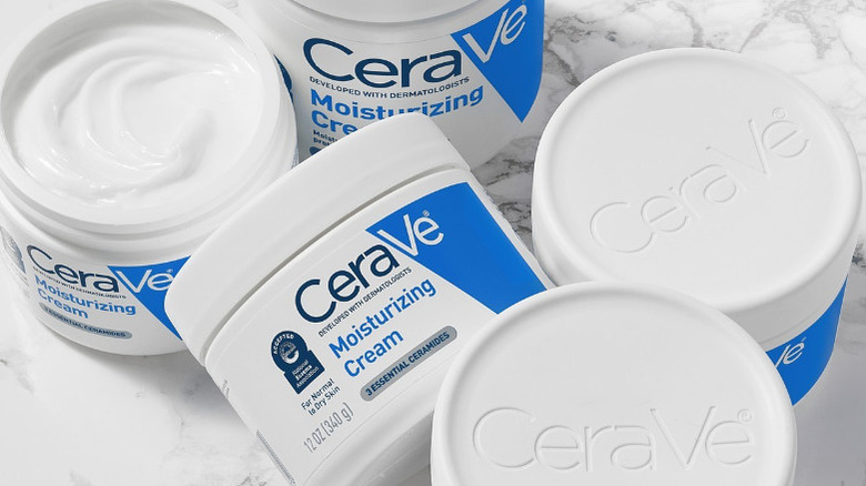 Pots of CeraVe cream marble table