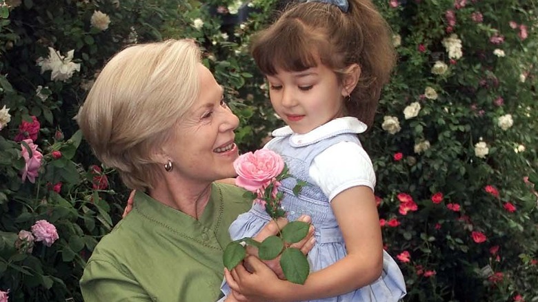 Katharine Duchess of Kent holding a child 