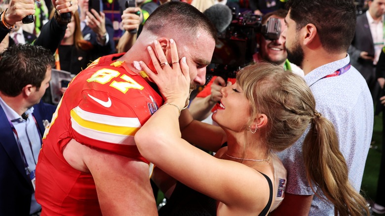 Taylor Swift embracing Travis Kelce