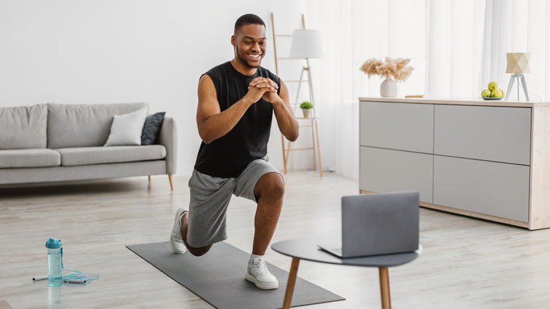 person doing lunges in living room 