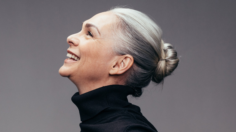 older woman with gray hair sporting a sleek bun 