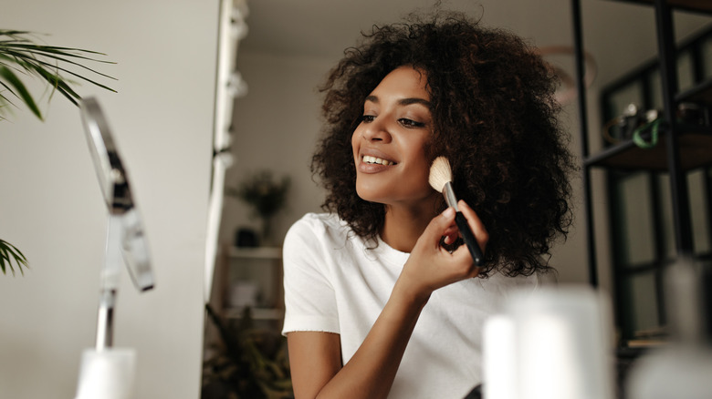 woman putting on makeup