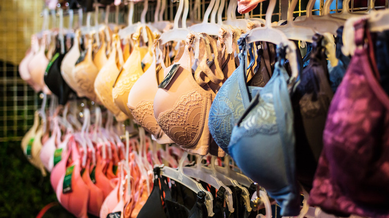 Different colored bras on a rack in a store