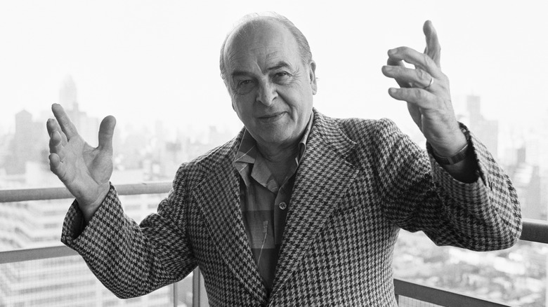 Carmine Coppola standing on a balcony and throwing his hands up