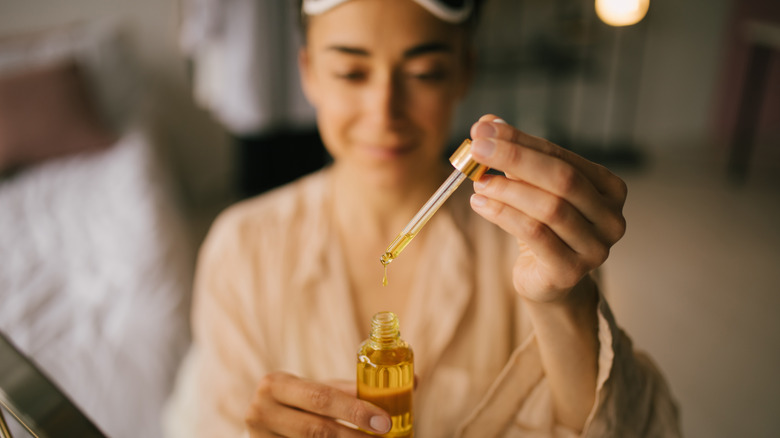 Woman with essential oils before bed