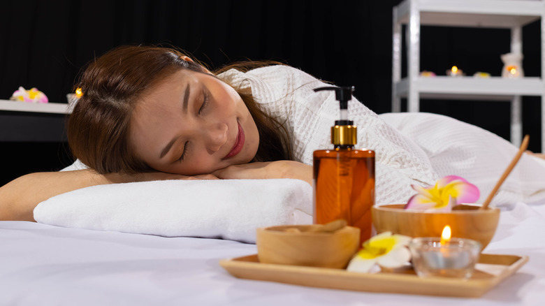 Woman using essential oils to sleep