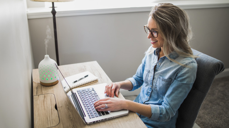 Woman works with diffuser next to her