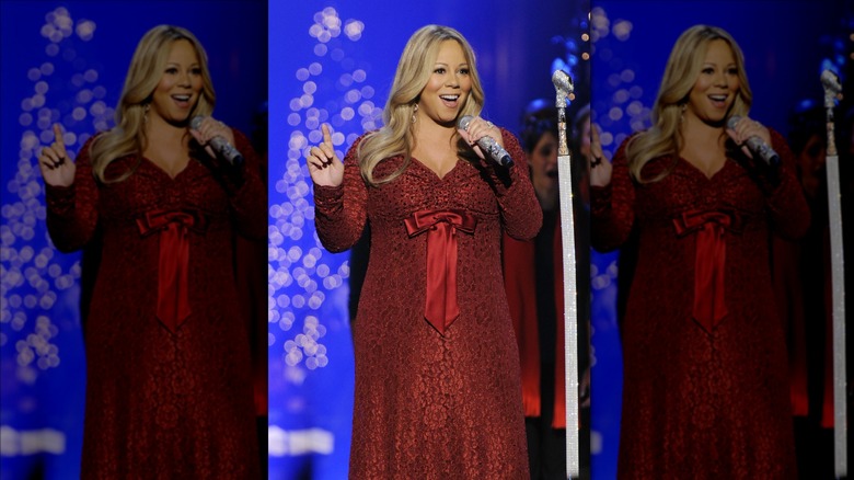 Mariah Carey wearing red, singing 
