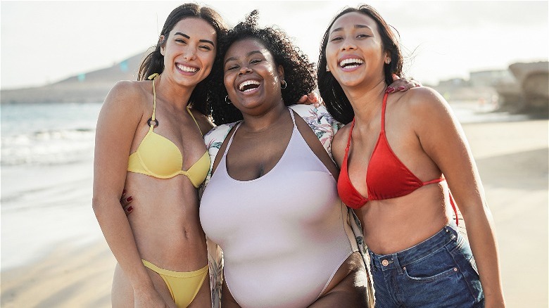 Three woman on beach smiling