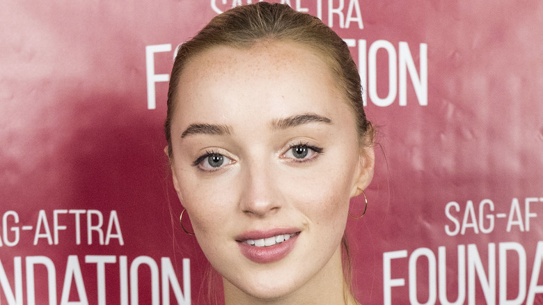 Phoebe Dynevor smiles at an event