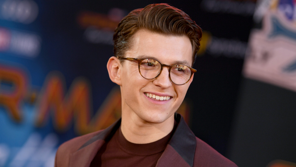 Actor Tom Holland smiling in glasses