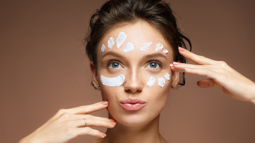 Woman with eye cream on her face