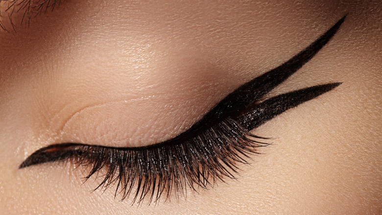 Close-up of closed eye with double-winged eyeliner