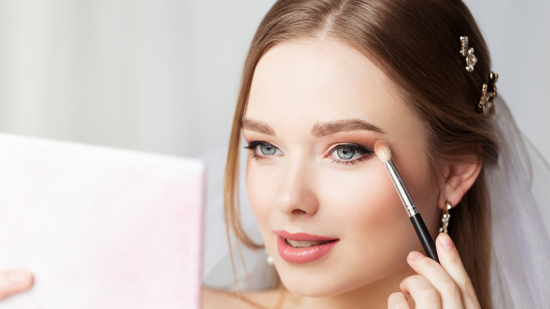 Woman applying eyeshadow