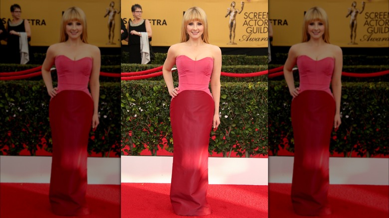 Melissa Rauch in a pink and red dress