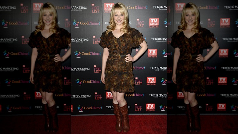 Melissa Rauch in a brown dress with a feather print