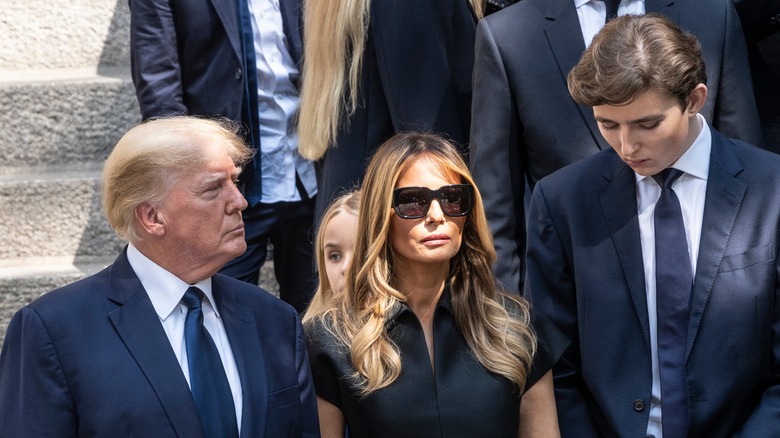 Donald Trump, Melania Trump, and Barron Trump standing together