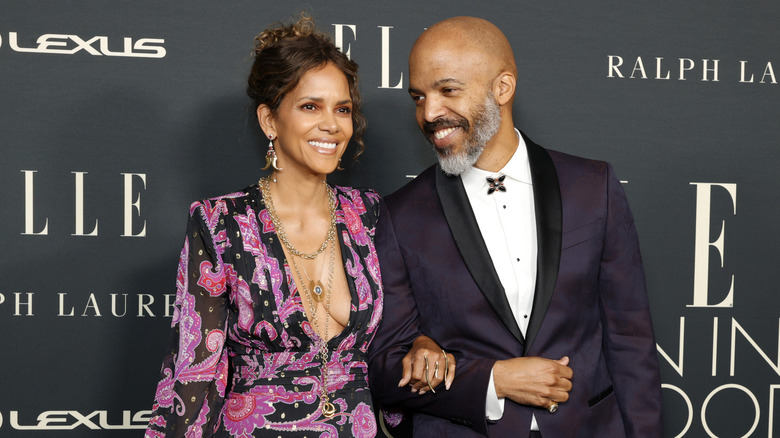 Halle Berry and Van Hunt smiling on the red carpet