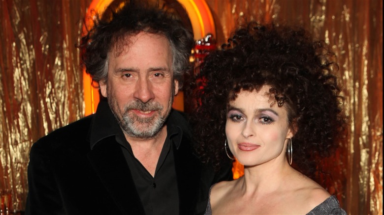 Tim Burton and Helena Bonham Carter posing at a red carpet event in 2013