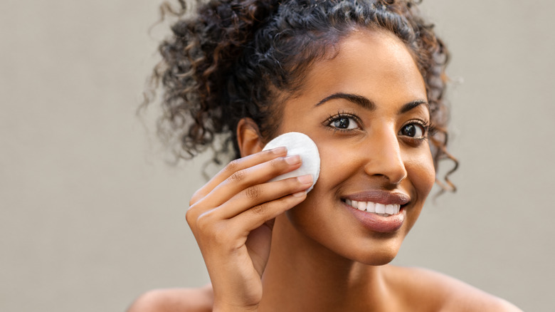 Woman cleaning her face