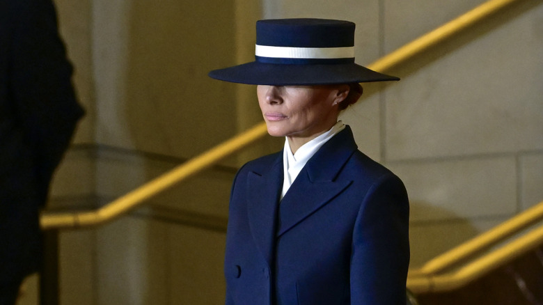 melania trump scowling in a hat