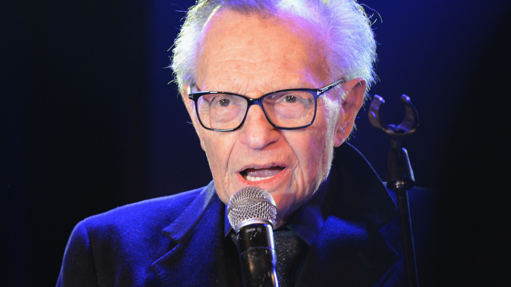 Larry King speaking with microphone