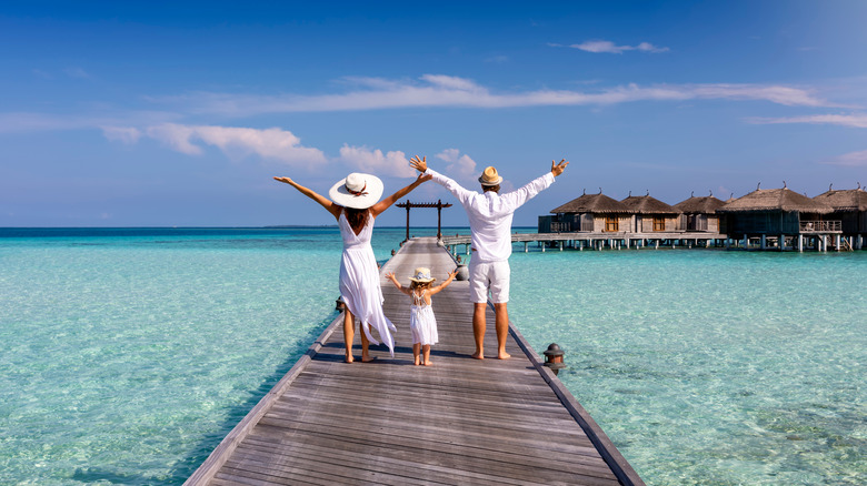 Family on walkway in Maldives