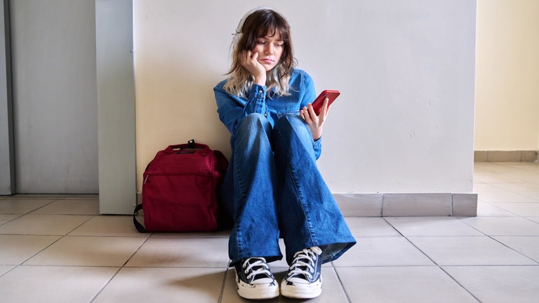 unhappy girl with smartphone