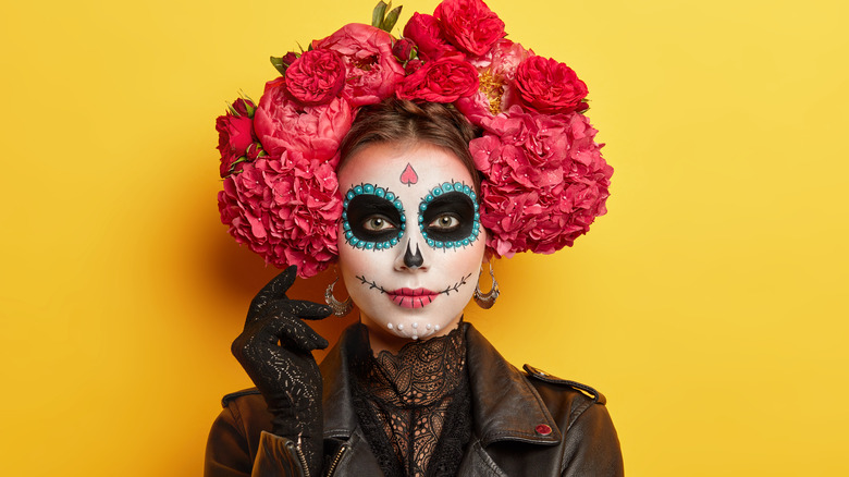 A woman wearing a full face of Halloween makeup 