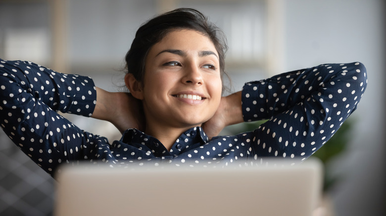 A woman resting at her desk 