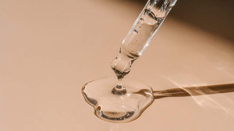 Skincare serum poured out onto table 