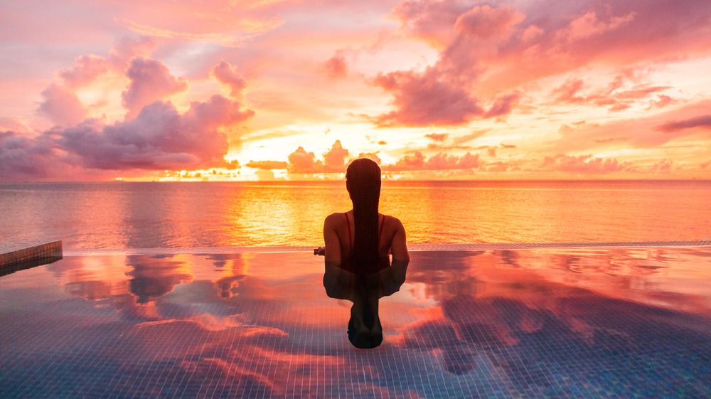 Woman watching the sunset on the beach