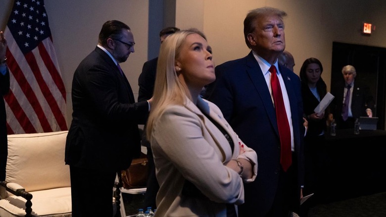 Karoline Leavitt in gray blazer with President Donald Trump in red tie