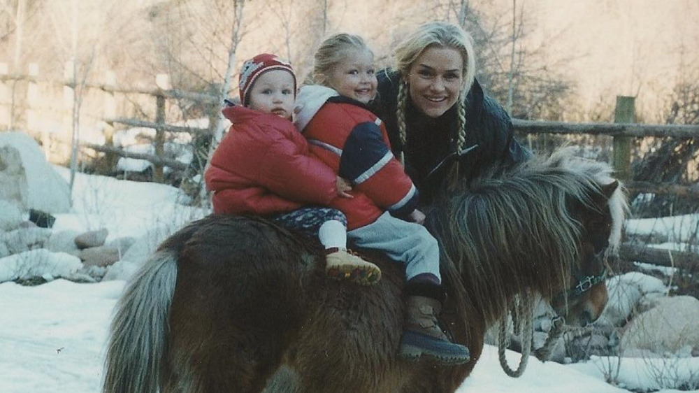 Bella Hadid, left, and Gigi Hadid, right, posing on a pony with supermodel mom Yolanda Hadid.