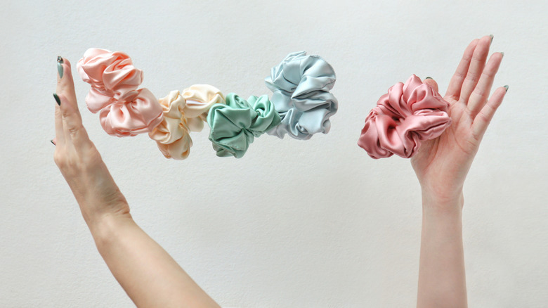 Woman plays with silk scrunchies