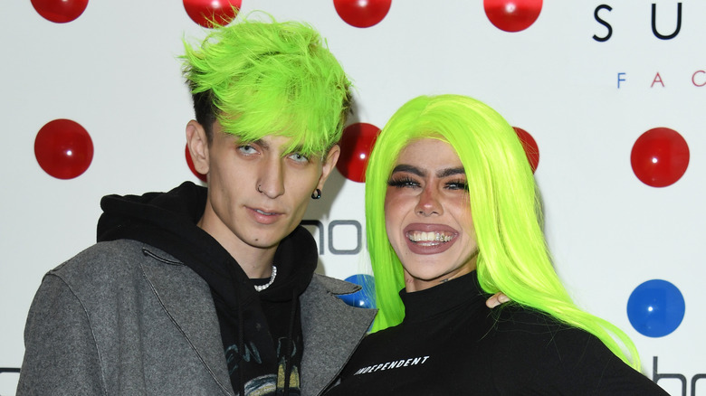 man and woman bright green hair