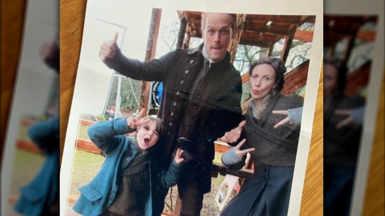 Sam Heughan and Catriona Balfe bts polaroid