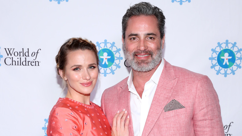 Shantel VanSanten and Victor Webster posing at event