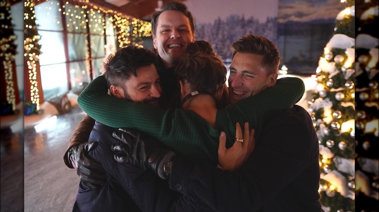 Tyler Hynes, Paul Campbell, Andrew Walker, and Kimberley Sustad embracing in a group hug