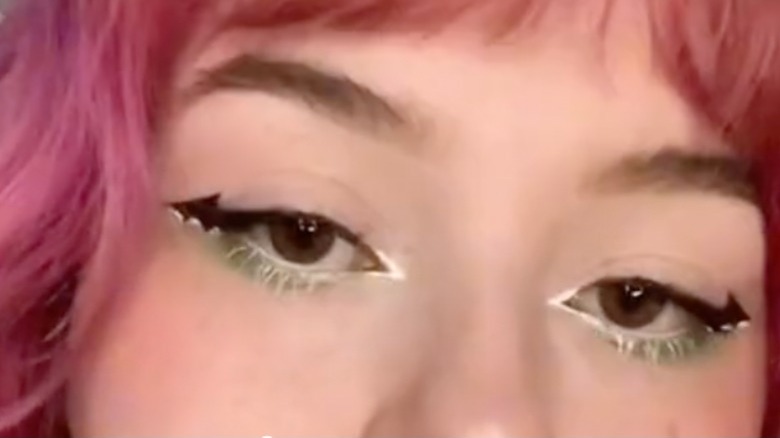 woman wearing bat-shaped eyeliner